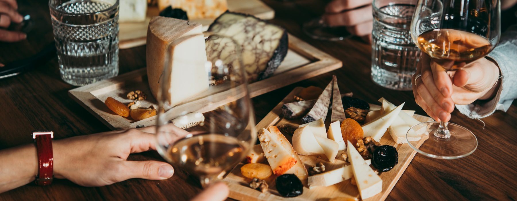 a table with food and glasses of wine